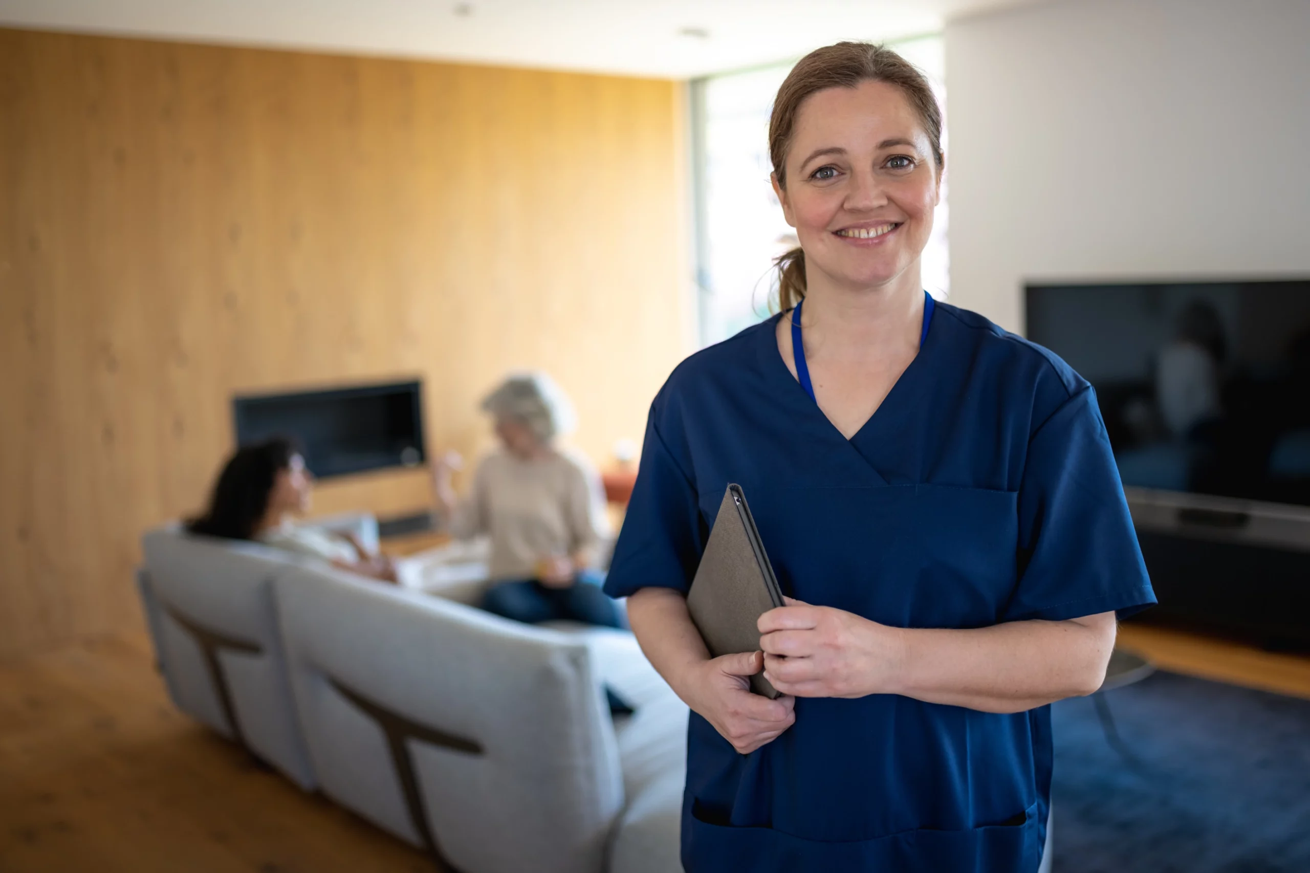 A nurse standing in a living room.