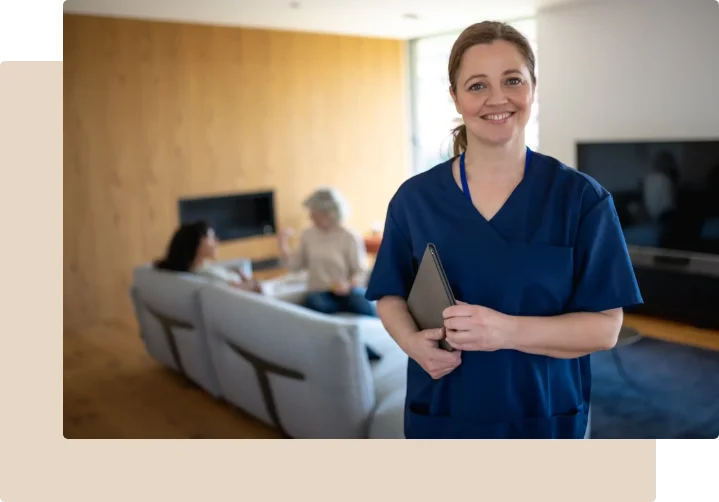 Professional in-home caregiver in blue scrubs